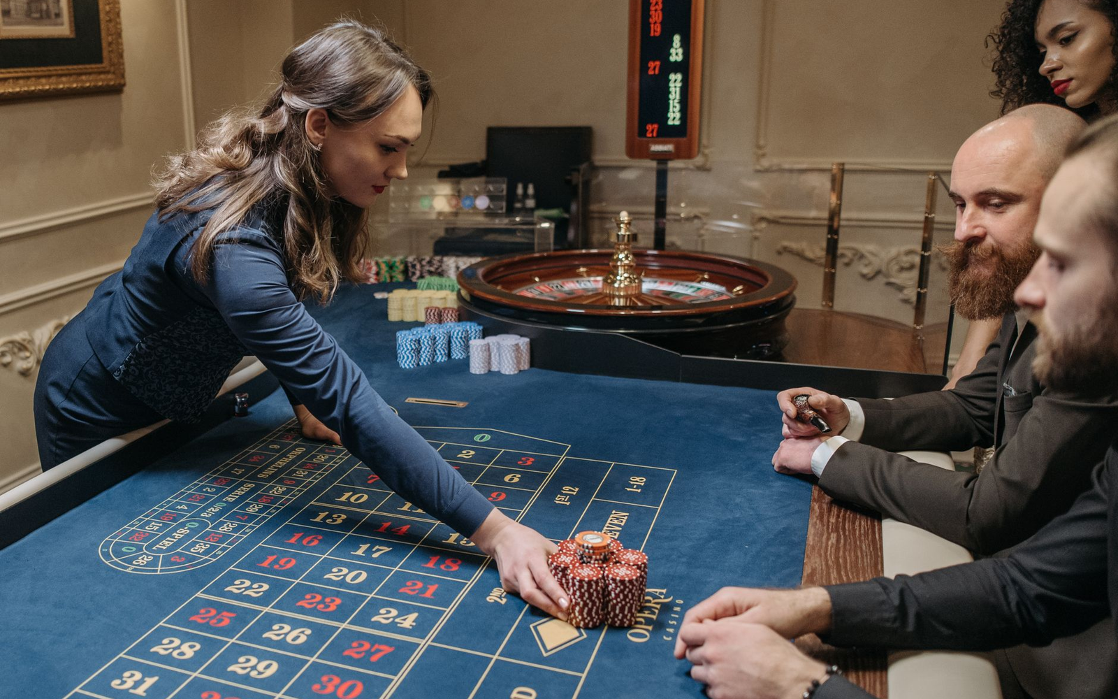 Three baize tables set up in a function room with croupier-hosts and adult guests in formal wear