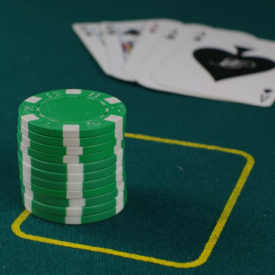 Blank coloured prop discs stacked on green baize next to two cards showing only a back pattern
